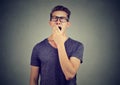 Young man yawning with hand over his mouth Royalty Free Stock Photo