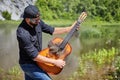 One bearded man uses a steaming guitar