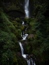 Young man in yellow jacket in front of El Chorro de Giron waterfall cascade cataract near Cuenca Azuay Ecuador