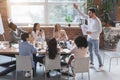 Young manager cheering up his young business team Royalty Free Stock Photo