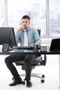 Young manager sitting in modern office