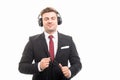 Young manager wearing headphones enjoying music