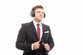 Young manager wearing headphones listening to music