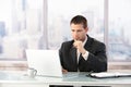 Young manager working on laptop in office