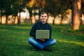 The young manager working on a laptop in the park. Lunch Break. Royalty Free Stock Photo