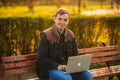 The young manager working on a laptop in the park. Lunch Break. Royalty Free Stock Photo