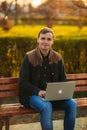 The young manager working on a laptop in the park. Lunch Break. Royalty Free Stock Photo