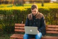 The young manager working on a laptop in the park. Lunch Break. Royalty Free Stock Photo