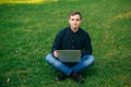 The young manager working on a laptop in the park. Lunch Break. Royalty Free Stock Photo