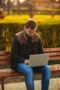 The young manager working on a laptop in the park. Lunch Break. Royalty Free Stock Photo