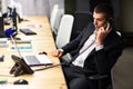 Young manager at the workplace. Young man working on computer in office Royalty Free Stock Photo