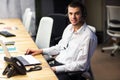 Young manager at the workplace. Young man working on computer in office Royalty Free Stock Photo