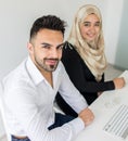 Young mand and woman working in office