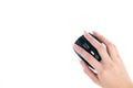 Young manicured girl hand holds a black wireless mouse on a white background. Top view Royalty Free Stock Photo