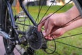 Young mans hands and bicycle wheel close up Royalty Free Stock Photo