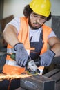 Young manual worker grinding metal in industry