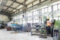 Young manual worker operating machinery in metal industry Royalty Free Stock Photo