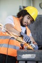 Young manual worker in protective workwear grinding metal in industry Royalty Free Stock Photo