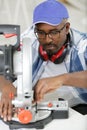 young manual worker using grinder on metal in factory Royalty Free Stock Photo