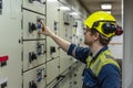 Young marine engineer during his round, checking operational parameters of engine room machineries on a merchant ship. Royalty Free Stock Photo