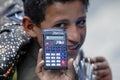 Young market seller demonstrates calculator to bargain the price in Sana'a, Yemen.