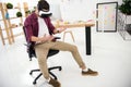young marketing manager in virtual reality headset at workplace
