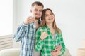 Young married couple with boxes and holding flat keys. Royalty Free Stock Photo