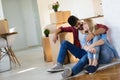 Young married couple with boxes and holding flat keys Royalty Free Stock Photo