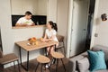 Young married couple chatting at breakfast in the kitchen area