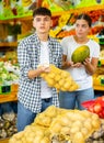 Happy young couple chooses products Royalty Free Stock Photo