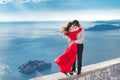 Young married couple embracing. Fashion girl in red dress with h Royalty Free Stock Photo