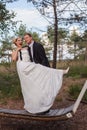 Young married couple is frivolous on a large swing.