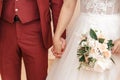 Young married couple holding hands, ceremony wedding day. Royalty Free Stock Photo