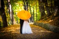 Young married couple in love kissing under umbrella