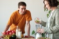 Young married couple makes a smoothie Royalty Free Stock Photo