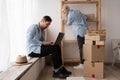 young married couple move in new home, relax on floor after unpacking things use laptop for searching home decoration Royalty Free Stock Photo