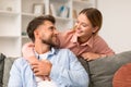 Young married couple sharing casual embrace on their sofa indoor Royalty Free Stock Photo