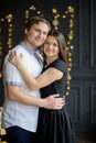 Young married couple stand gently having embraced.