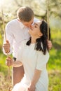 Young married couple, on a swing in a flowered garden or park. Warmly, love, spring and summer mood Royalty Free Stock Photo