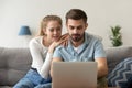 Young married couple using laptop searching booking online at home Royalty Free Stock Photo