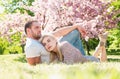 Young married people in love enjoying the spring beautiful nature. Beautiful young couple enjoying flowering garden. Man Royalty Free Stock Photo