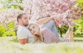 Young married people in love enjoying the spring beautiful nature. Beautiful young couple enjoying flowering garden. Man Royalty Free Stock Photo
