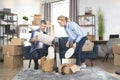 Young Caucasian couple packing boxes for moving to new house Royalty Free Stock Photo