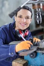 Young mechanic apprentice working on milling machine