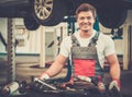 Young mechanic in a car workshop