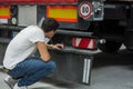 Young Mechanic Inspecting Freight Truck