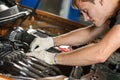 Young mechanic repairs the car engine Royalty Free Stock Photo