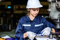 Young mechanical engineer repairing engine machine at repair shop