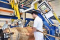 young mechanical engineering workers operate a machine for winding copper wire - manufacture of transformers in a factory Royalty Free Stock Photo