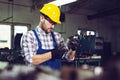 Mechanical technician measuring with caliper in workshop